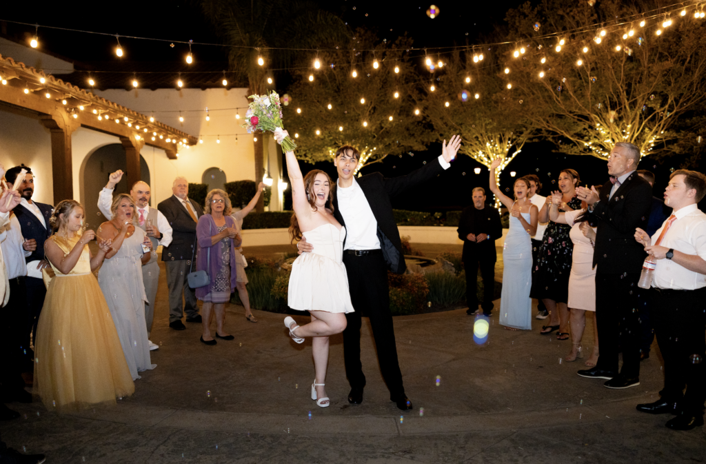 Bubble exit at San Diego wedding couple puts hands up in excitement